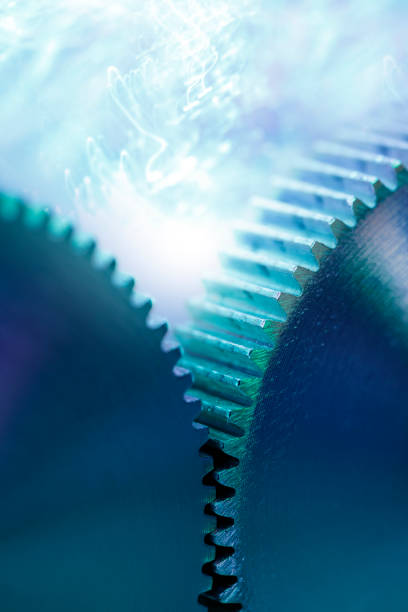 Gears and Energy Gears with blue glowing high energy lightning. quantum photos stock pictures, royalty-free photos & images