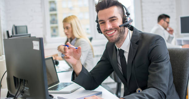 istock Happy young male customer support executive working in office. 1214768771