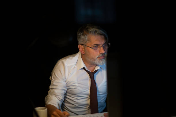 istock Serious businessman thinking of problem solution working late in office 1214769492