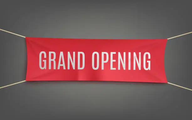 Vector illustration of Realistic red grand opening banner hanging on a grey wall