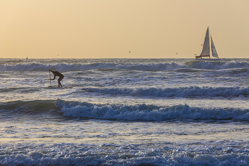 Herzliya, Israel - March 05, 2020: Surfer surfing on the Mediterranean coast