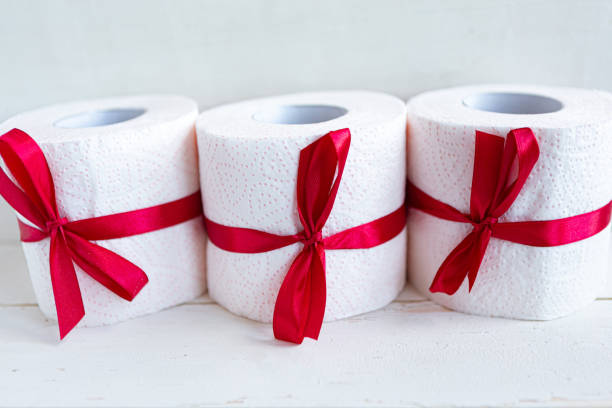istock Three toilet paper rolls wrapped in gift bow. Covid19 concept 1214773912