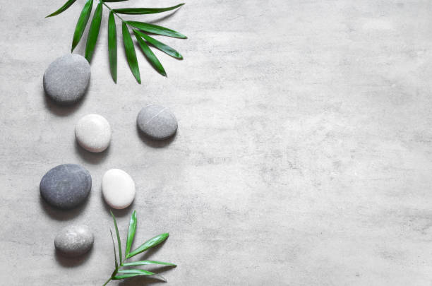 istock Grey spa background, spa concept, palm leaves and grey stones, top view. 1214776816