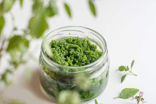 istock pesto sauce in a jar on a white background 1214778283