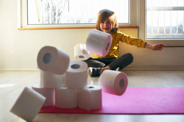 istock Child playing with toilet paper 1214779778