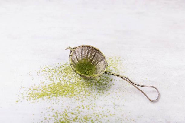 Vintage metal strainer with Matcha tea. Top View. Copy Space stock photo