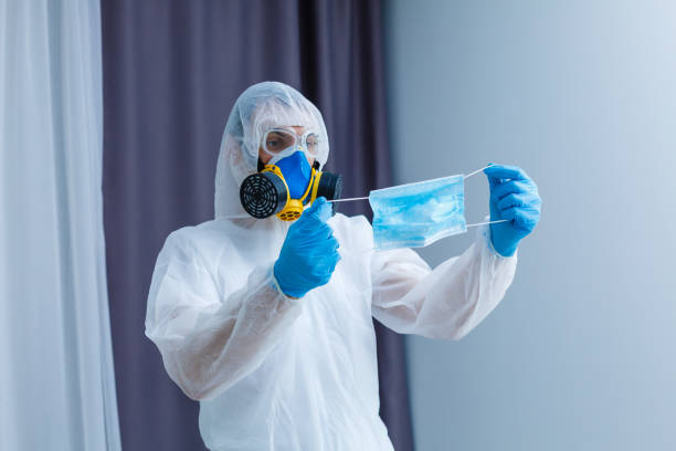 istock Man wearing chemical protective suit on light grey background. Coronavirus outbreak 1214781492