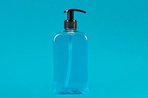 istock Liquid soap dispenser on blue background with copy space 1214784735