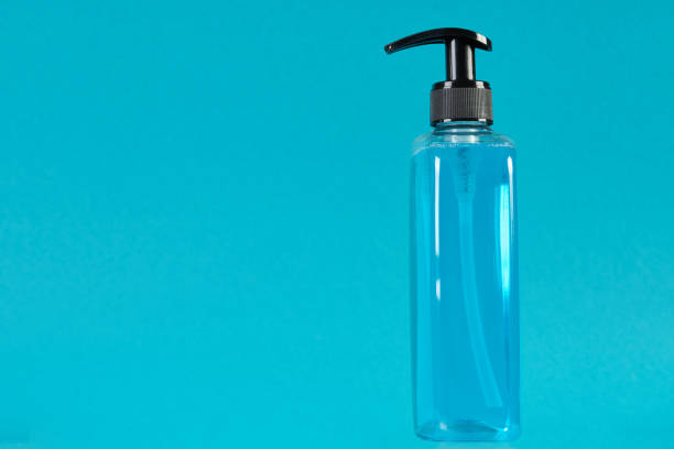 istock Liquid soap dispenser on blue background with copy space 1214784740