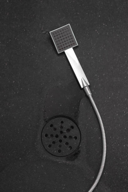 istock shower head laying on natural stone floor and gutter in top view 1214792538