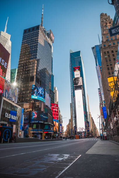 Times square New York City during 2020 current events with no people New York City, NY: 3/21/2020 The view of Times square New York City during 2020 current events with no people or hardly any people walking by. New York City comprises 5 boroughs sitting where the Hudson River meets the Atlantic Ocean. At its core is Manhattan, a densely populated borough that’s among the world’s major commercial, financial and cultural centers. Its iconic sites include skyscrapers such as the Empire State Building and sprawling Central Park. Broadway theater is staged in neon-lit Times Square. to the struggle against world terrorism statue photos stock pictures, royalty-free photos & images