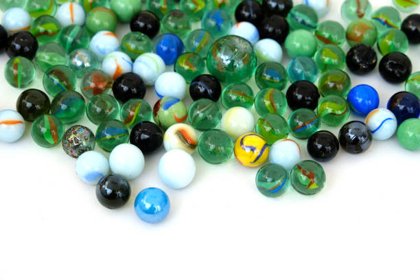 istock fun game for kids with colored glass marbles, glass balls, 1214794160