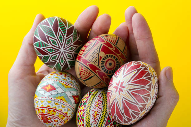 istock happy easter card. girl holds in hands beautiful Easter egg Pysanka handmade - ukrainian traditional 1214794300