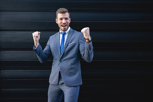 Happy adult businessman smiling after get promoted from the company he work for it