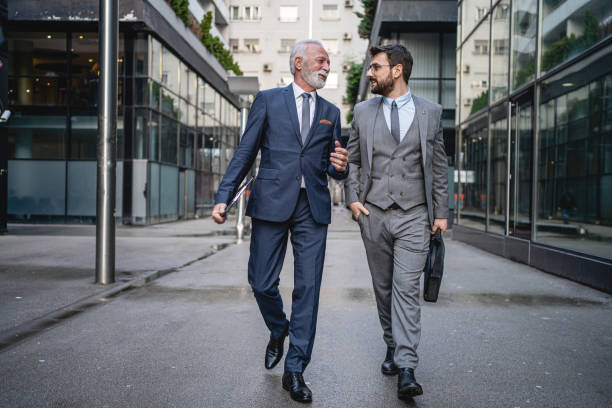 istock Senior CEO and his right hand talking about new project 1214796974