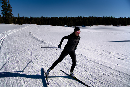 A young woman enjoying a day of cross country skiing in western Colorado