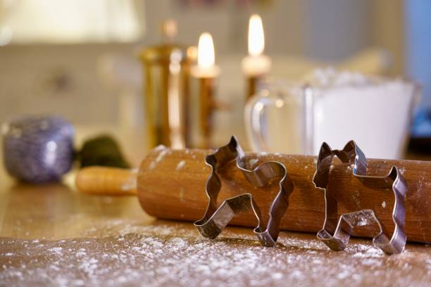 A couple of cookie cutters in the shape of dogs on a cactus able with baking gears