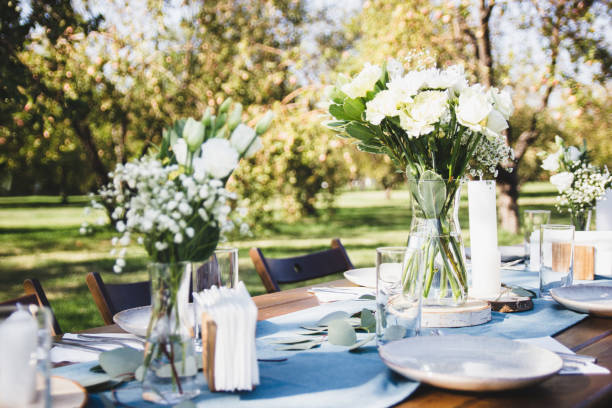 istock Festive table setting on a background of blue napkins. Tree branch. 1214799845