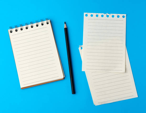 istock open notebook in line and a black wooden pencil 1214800180