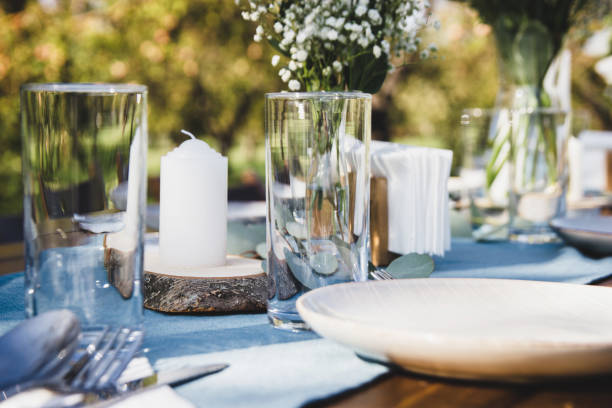 istock Festive table setting on a background of blue napkins. Tree branch. 1214800256