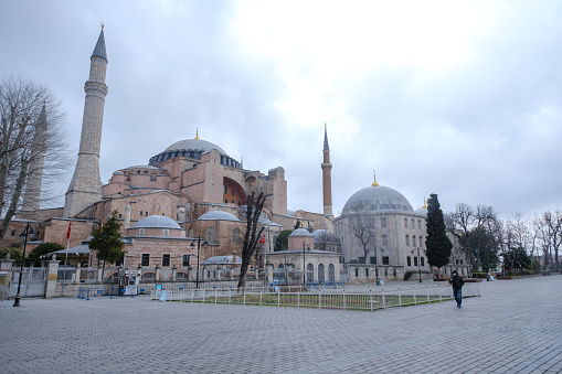 Istanbul, Turkey - 25 March, 2020:  Hagia Sophia Museum (Ayasofya in Turkish), normally filled with tourists, are almost empty. One person shooting with his camera on empty square. Coronavirus cases continued to spread in the country .