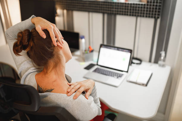 Woman stretching her neck while working at home Working from home neck photos stock pictures, royalty-free photos & images