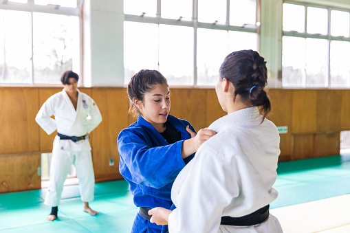 Young female athletes practicing Judo in Dojo