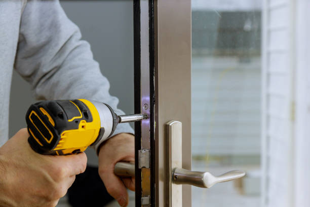 Locksmith hand holds the screwdriver in installing new house door lock Locksmith in installing new house door lock hand holds the screwdriver door lock stock pictures, royalty-free photos & images