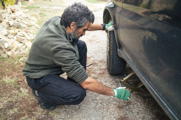 istock Changing car tire on a country road. DIY 1214814620