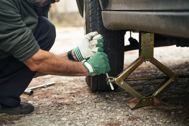 istock Changing car tire on a country road. DIY 1214814628