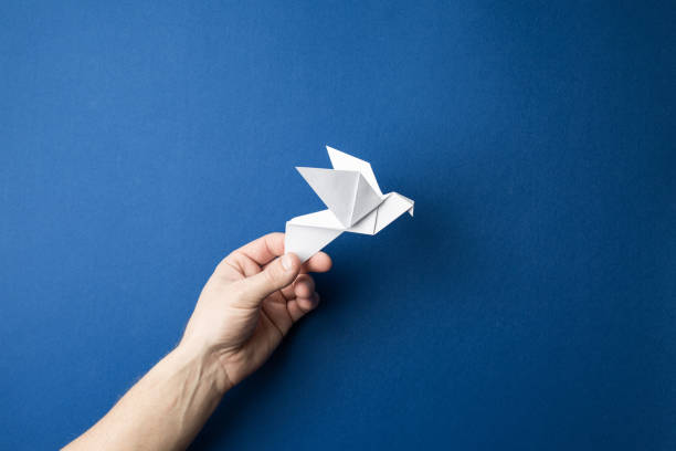 istock Paper pigeon on a blue isolated background. 1214816465
