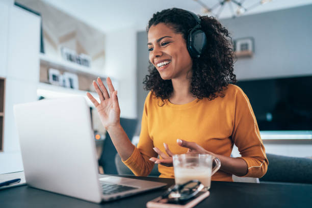 Business Video Conference Young modern woman having Video Conference at home voip stock pictures, royalty-free photos & images