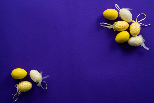 Yellow easter decorative eggs Yellow easter decorative eggs on a dark purple background artificial flower stock pictures, royalty-free photos & images