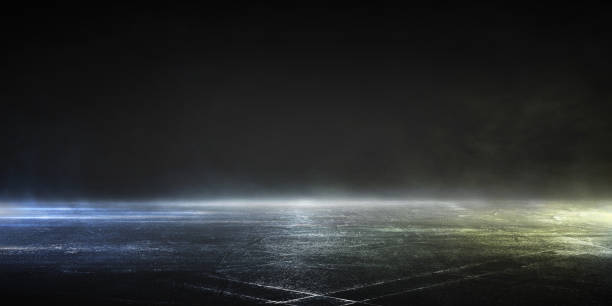 istock 3D rendering wet asphalt, reflection of neon lights, a searchlight, smoke. Abstract light in a dark empty street with smoke, smog. Dark background scene of empty street, night view, night city. 1214829703