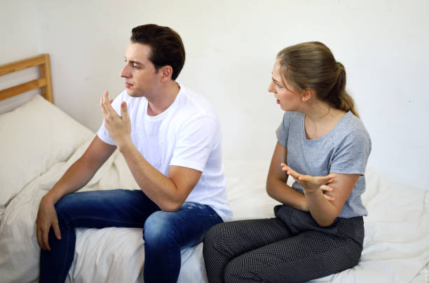 istock Young lovers sit sadly in the bedroom and bored with love problems. 1214834299