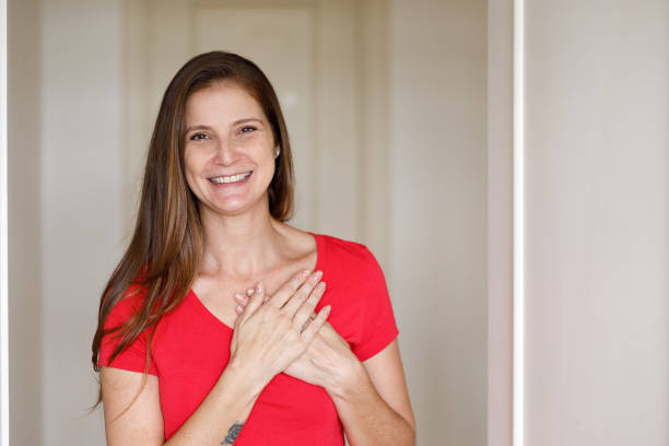 Smiling woman doing social distance greeting