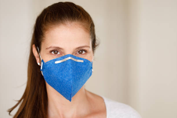 istock Young woman wearing mask and looking at camera 1214835582