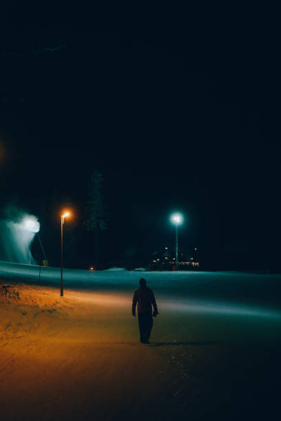 istock Man walking in the winter night 1214836778