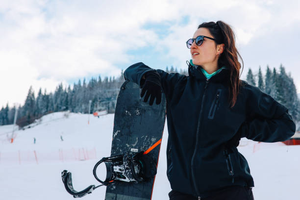 istock Woman resting after snowboarding 1214839613