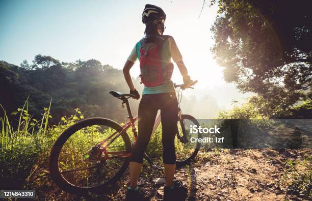Young Woman Cyclist Enjoy The Beautiful Sunrise On Summer Forest Trail Stock Photo - Download Image Now