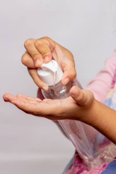 istock child putting alcohol gel on his hands, protection against coronavirus 1214843311