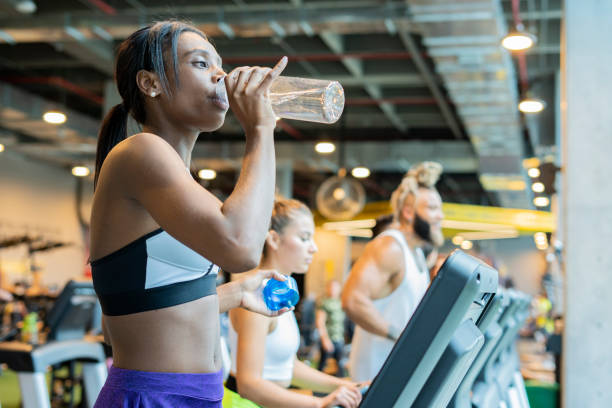 istock latin woman on gym treadmill 1214843364