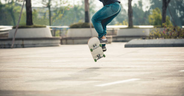istock Skateboarder skateboarding at sunrise park 1214847546