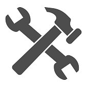 istock Crossed hammer and wrench solid icon. Repair tools and worker equipment symbol, glyph style pictogram on white background. Construction sign for mobile concept, web design. Vector graphics. 1214850842