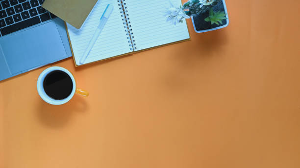 istock Top view image of computer laptop, coffee cup, pen, notebook, potted plant putting together on working desk. Orderly workplace concept. 1214851574