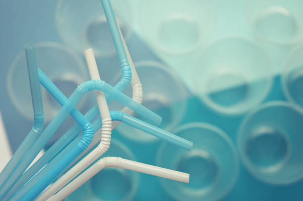istock White and blue plastic tubes, turquoise tone. Selective focus, top view. Plastic cups on the background. 1214853864