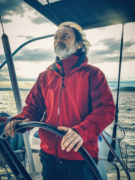 istock Skipper sailing on sailboat 1214854787