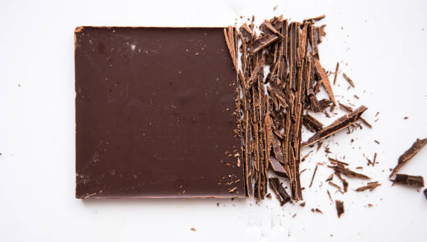 istock Broken craked chocolate parts isolated on white background 1214857273
