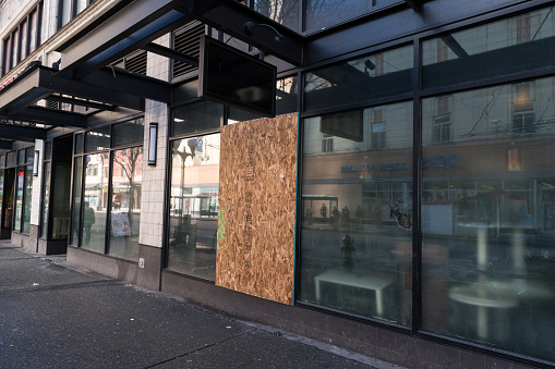 Seattle, USA – March 25, 2020: Late in the day a busted window on pike street boarded up and temporarily closed. Seattle has become one of the most affected states from the Covid-19.