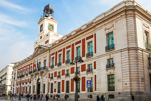 Madrid, Spain-February 11, 2020: Royal Mail House on Puerta del Sol square.\n The oldest building located on the Puerta del Sol square is the Royal mail House, built by order of Charles III in 1768. Today, this building is famous for its clock, under which the people of Madrid celebrate the New year.